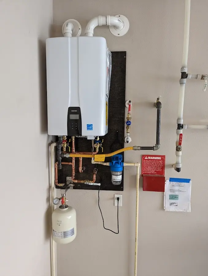 Professional plumber installing copper piping in a Brunswick home